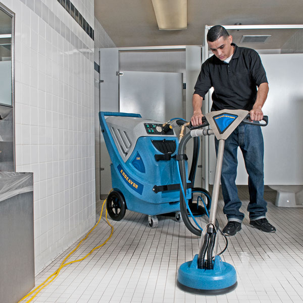 Commercial Floor Care Specialist Cleaning a Floor with Equipment