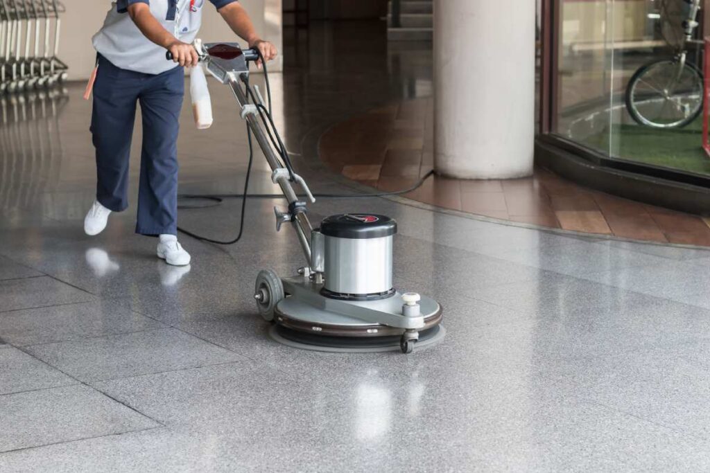 Worker polishing commercial floor